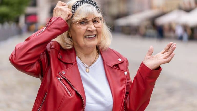 I dont know what to say. Confused senior woman feeling embarrassed about ambiguous question, having doubts, no idea, being clueless uncertain. Elderly grandmother walking in urban city street outdoors