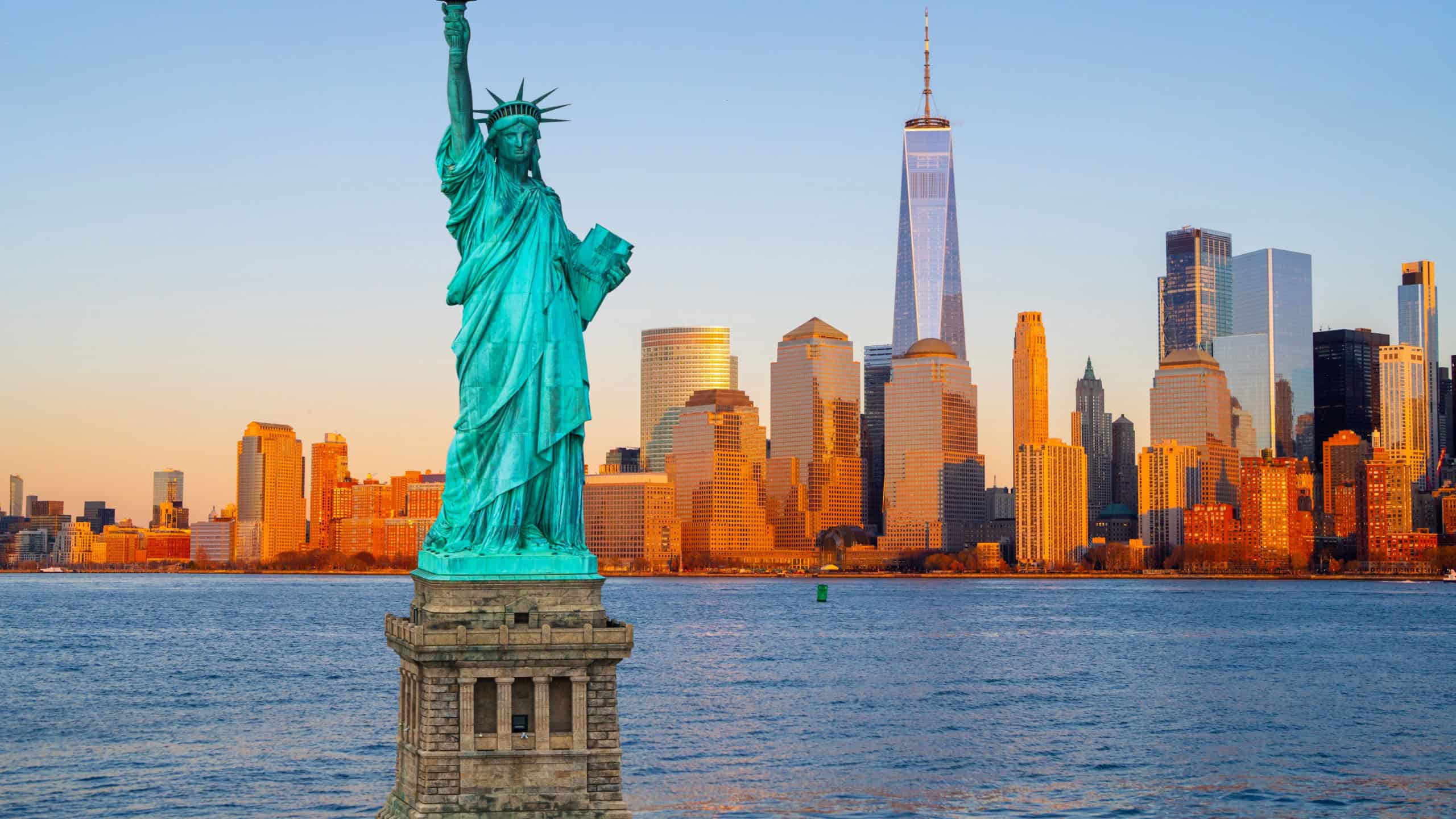 American Independence Day. NYC landscape with Statue of Liberty. Manhattan skyline Freedom Tower and Liberty Statue. New York City skyline with the Statue of Liberty over Hudson River.