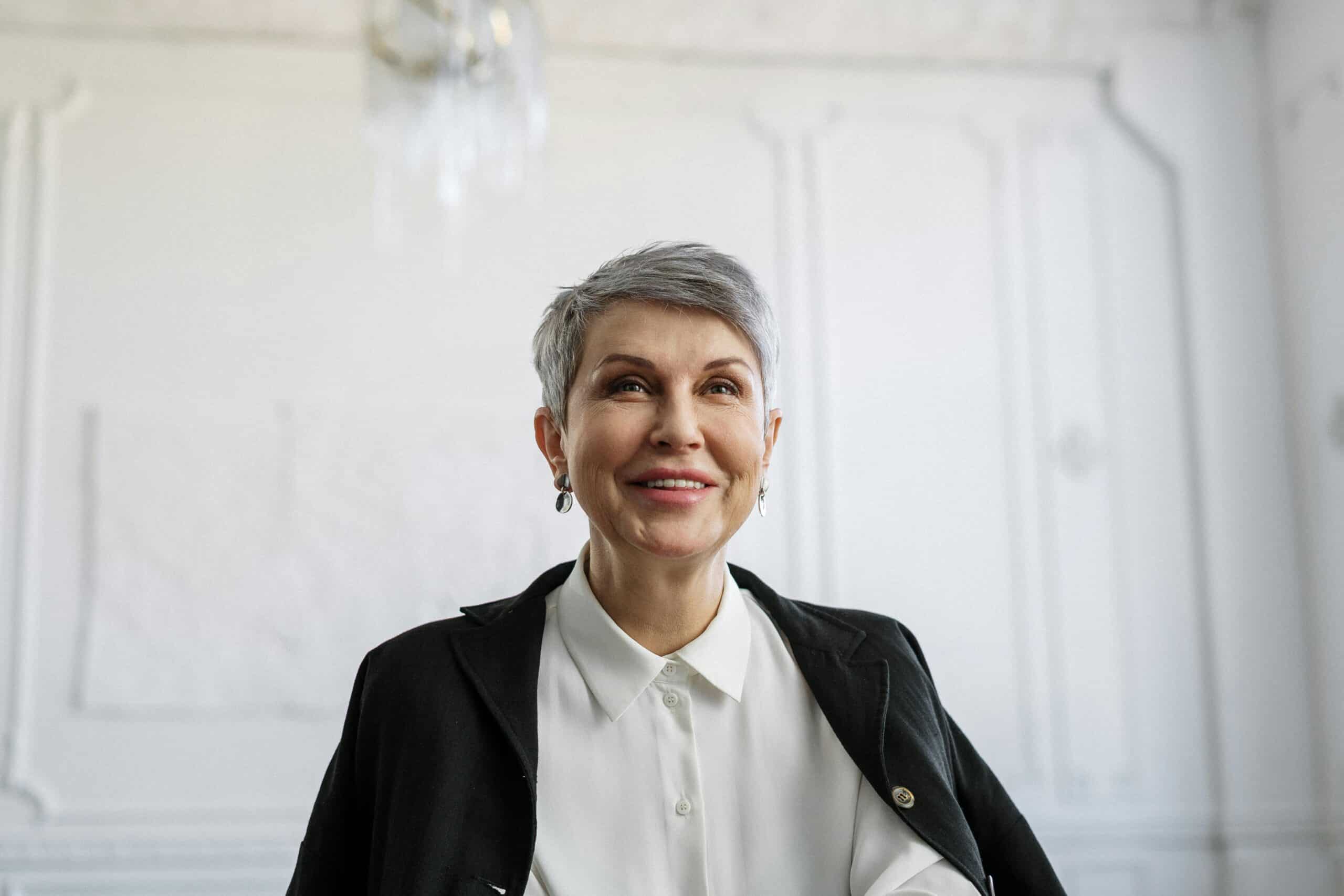 Smiling Senior Woman in Black Blazer, businesswomen, alone