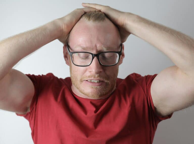 Upset male with headache taking break after intensive work
