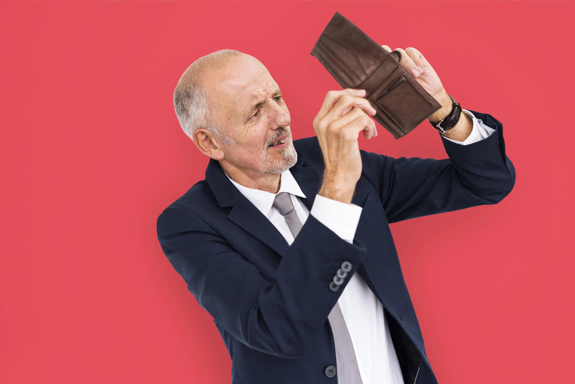 Businessman looking at empty wallet