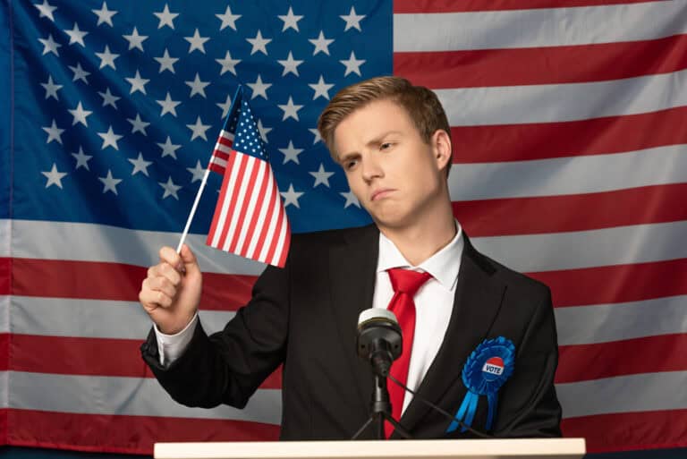 Displeased man on tribune and holding american flag