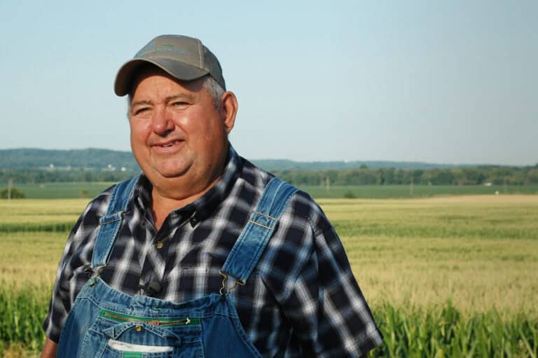 Farmer wearing overalls in a field