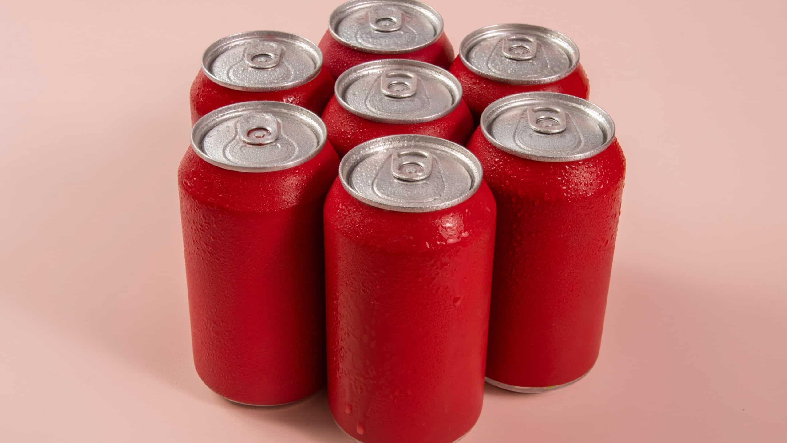 Group of aluminum soda cans, chilled, frozen and with water drops