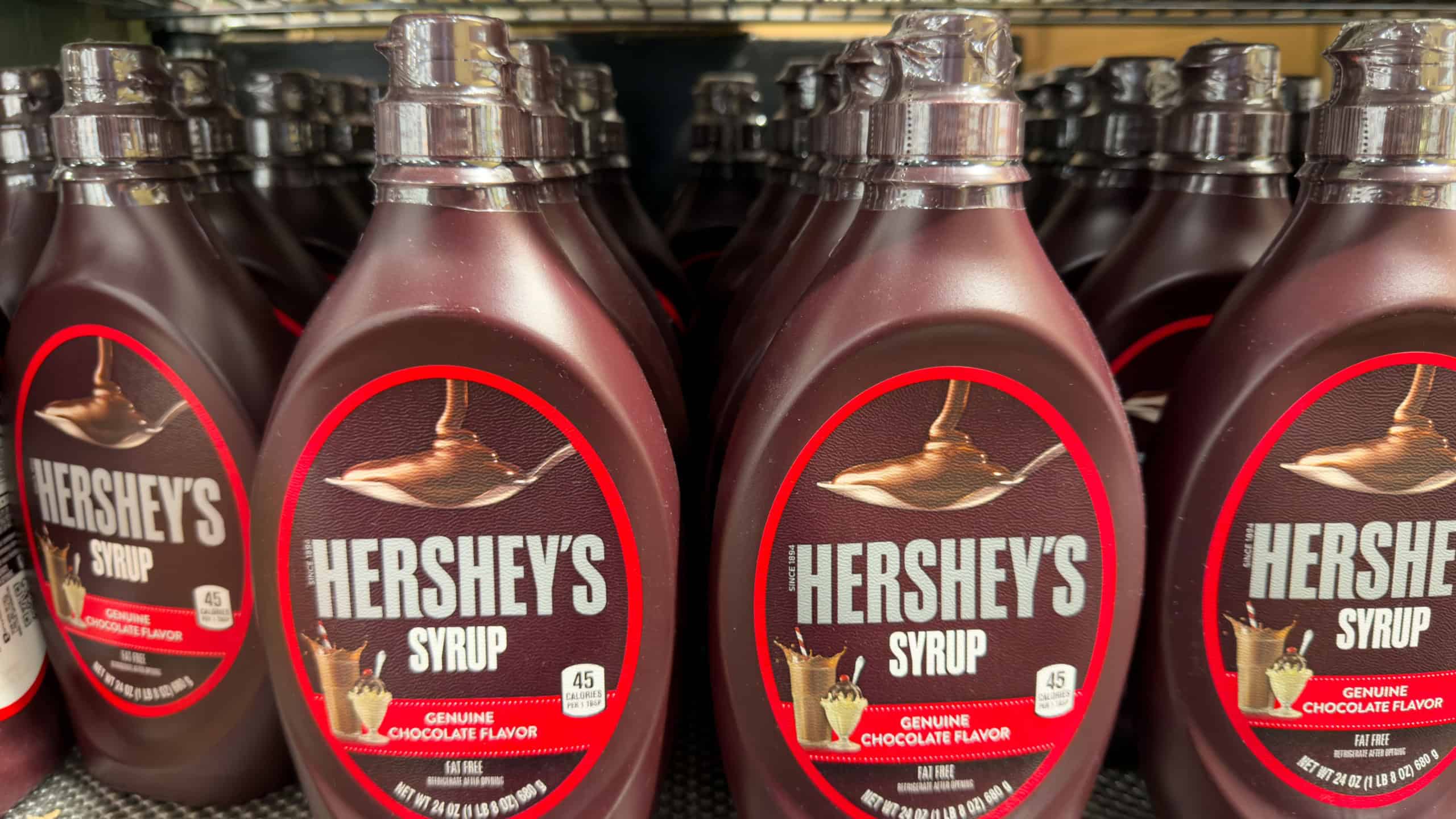 Los Angeles, CA - November 6, 2025: Hershey’s Chocolate Syrup Bottles Displayed on Grocery Store Shelf.