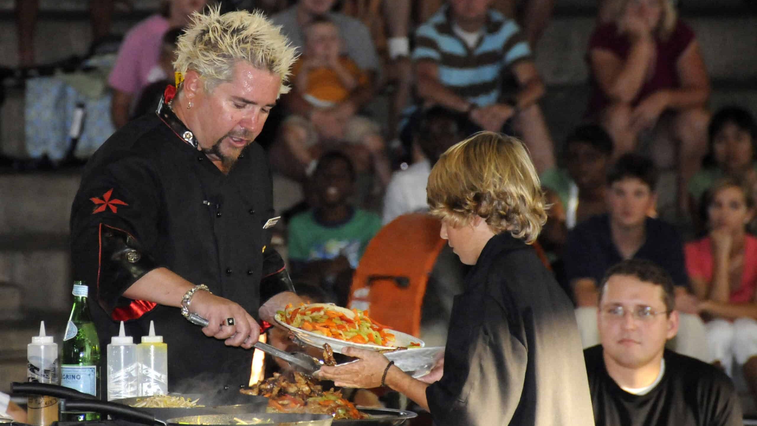 Guy Fieri and his son perform a cooking demonstration