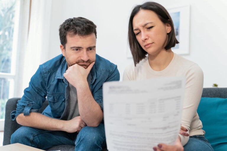 Desperate couple without money at home calculating family budget