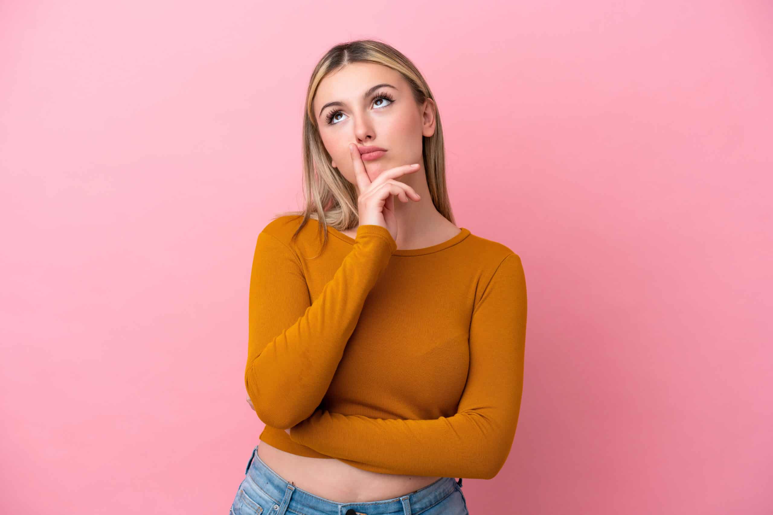 Young caucasian woman isolated on pink background