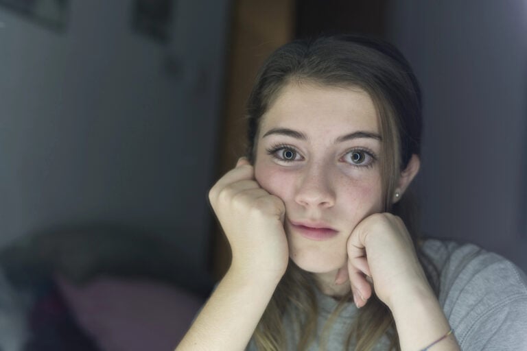 Portrait of teenage looking in a mirror