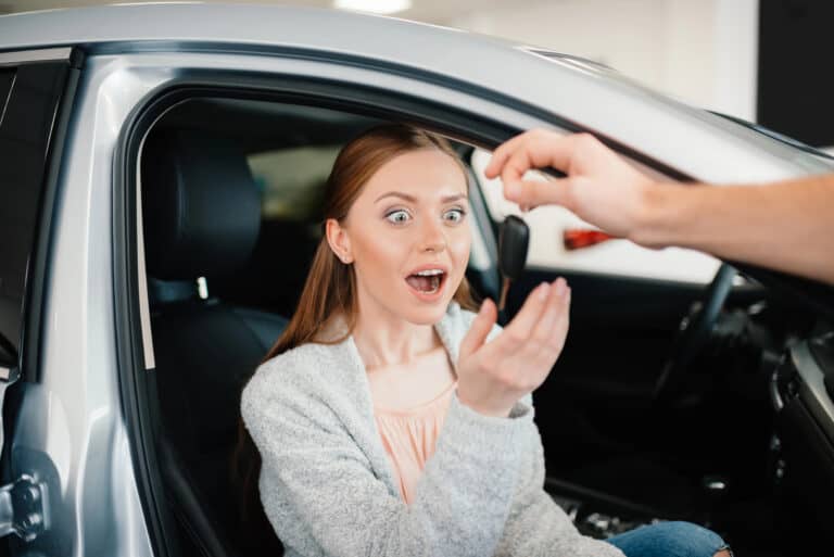 Excited woman in new car