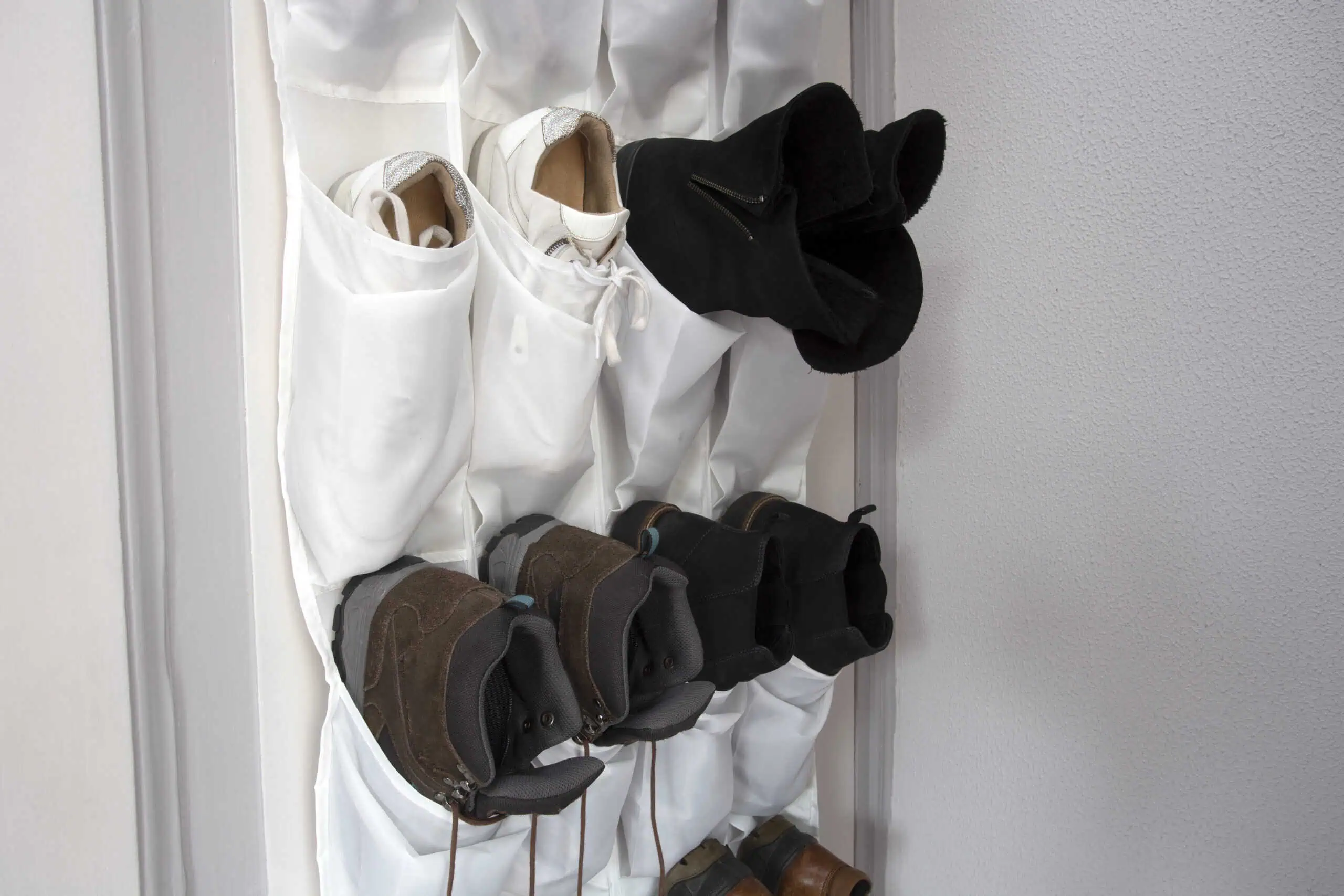 Shoe rack hanging on a wooden door, storage for shoes