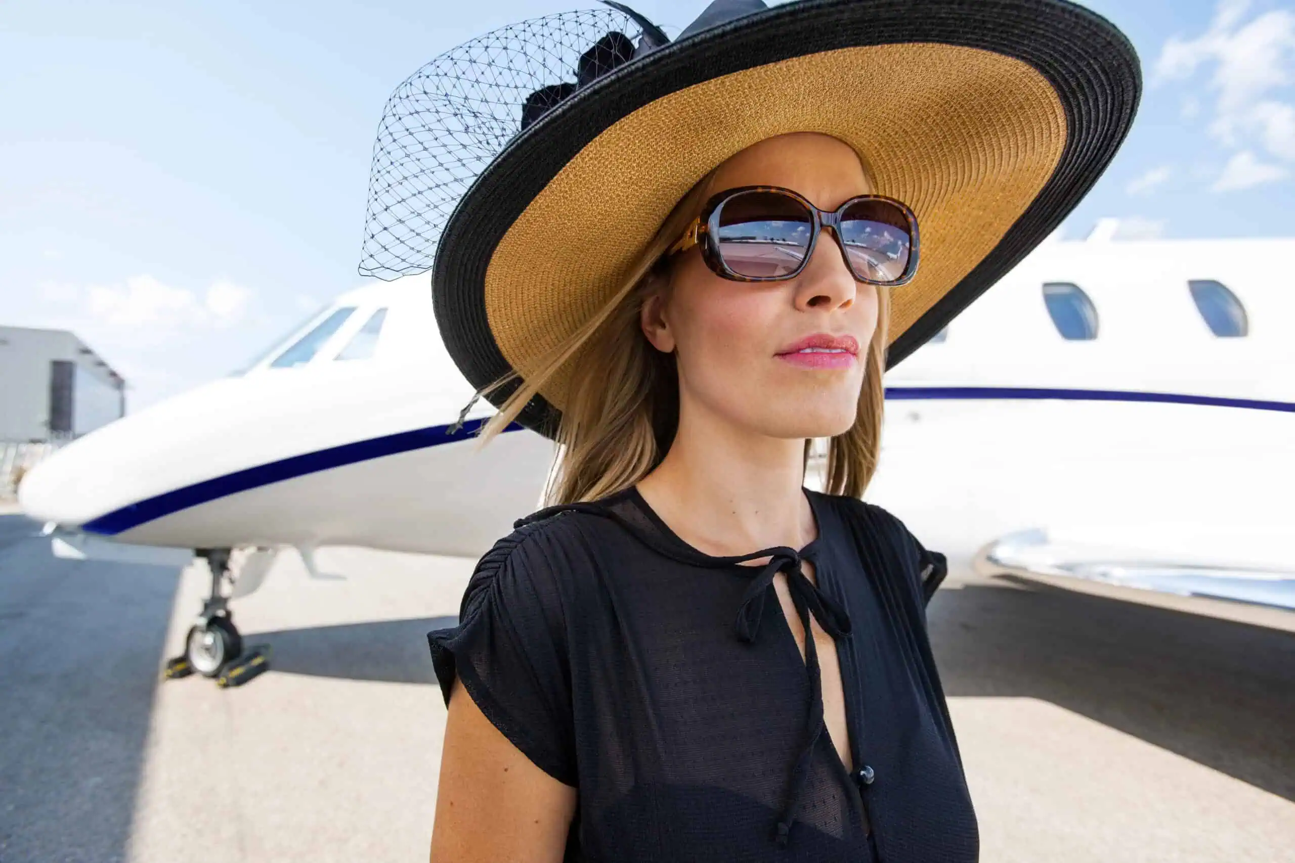 Elegant Woman Standing Against Private Jet