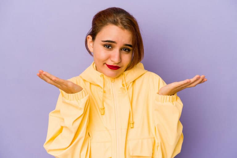 Young arab mixed race woman doubting and shrugging