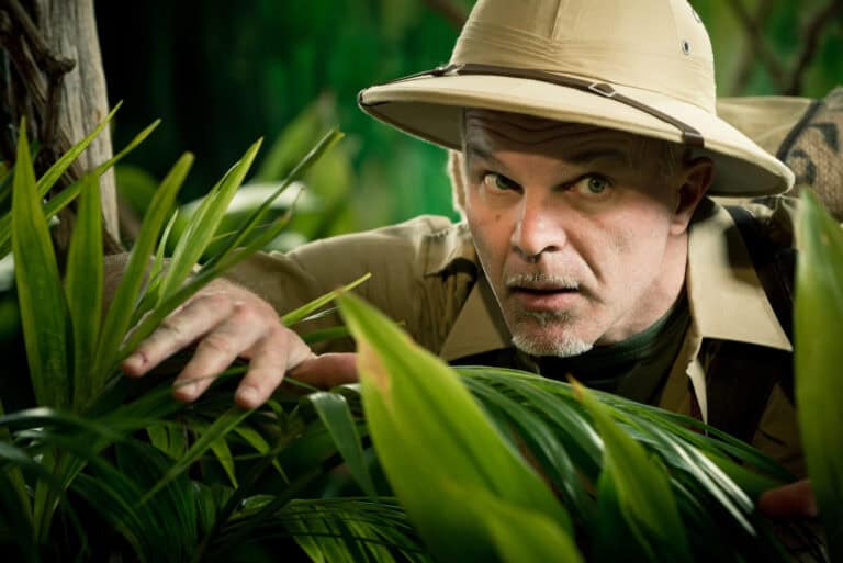 Adventurer peeking through plants