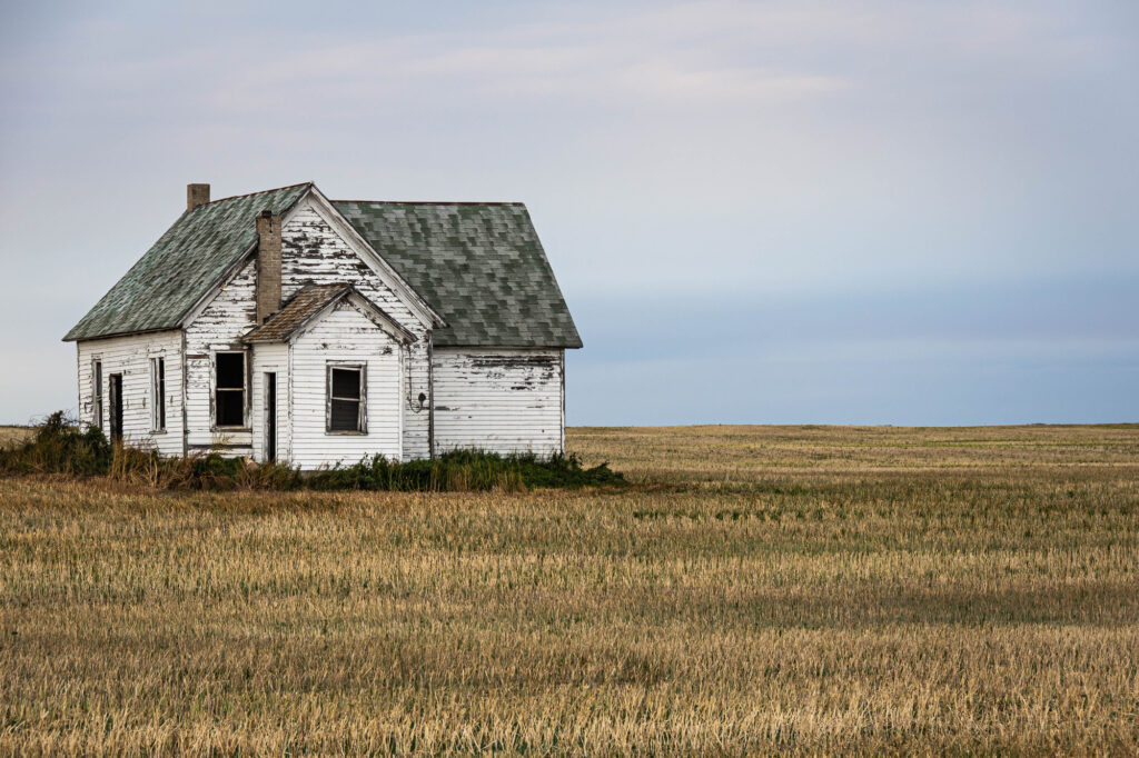 A little house on the prairie of North Dakota in the evening.