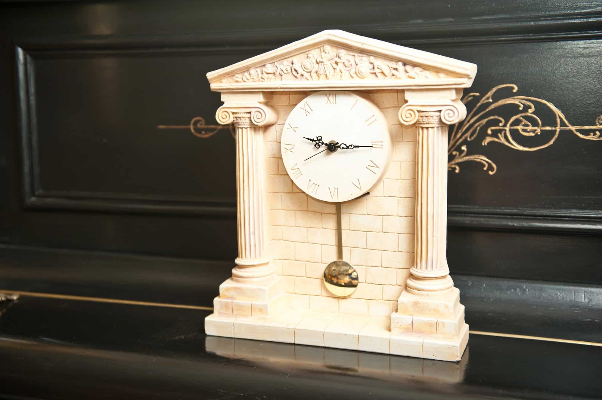 Elegant antique clock. Clock with Greek temple.