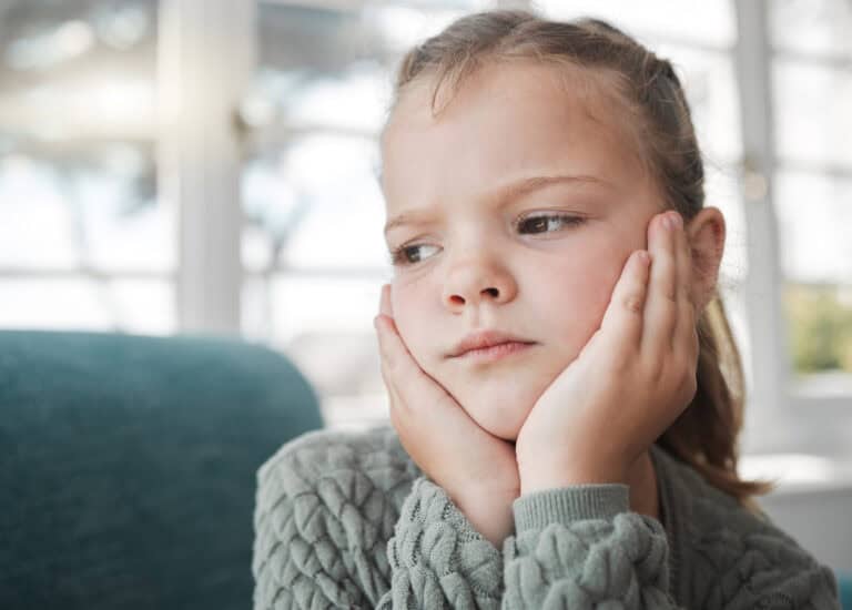 Someone looks a bit bored. a young girl looking bored at home