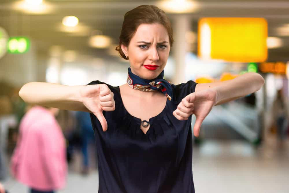 Pretty stewardess making bad signal inside the airport