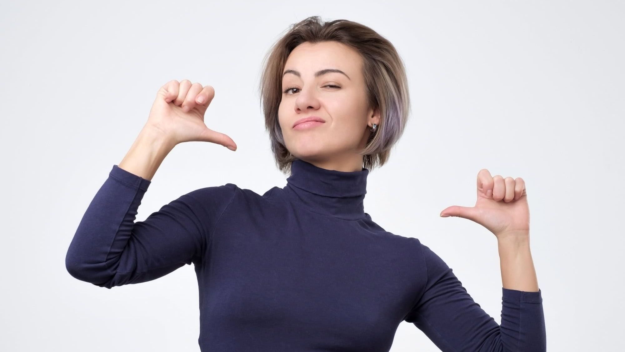 Young beautiful woman looking confident with smile on face, pointing herself with fingers being proud and happy.