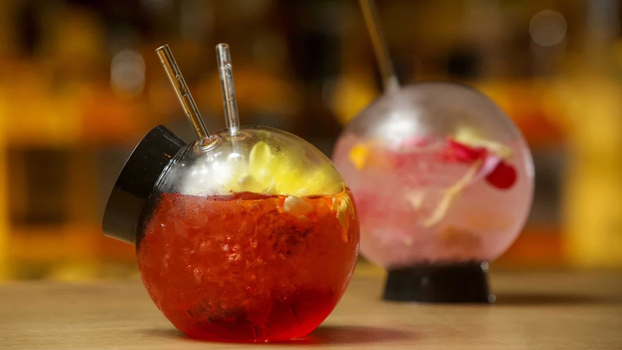 A glass of beautifully decorated red fishbowl cocktail