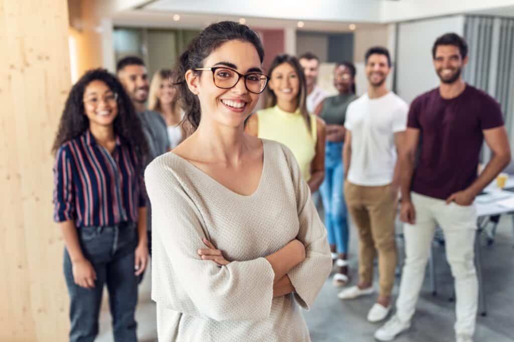 Shot of successful business team posing for presentation of work while looking at camera in a coworking space.