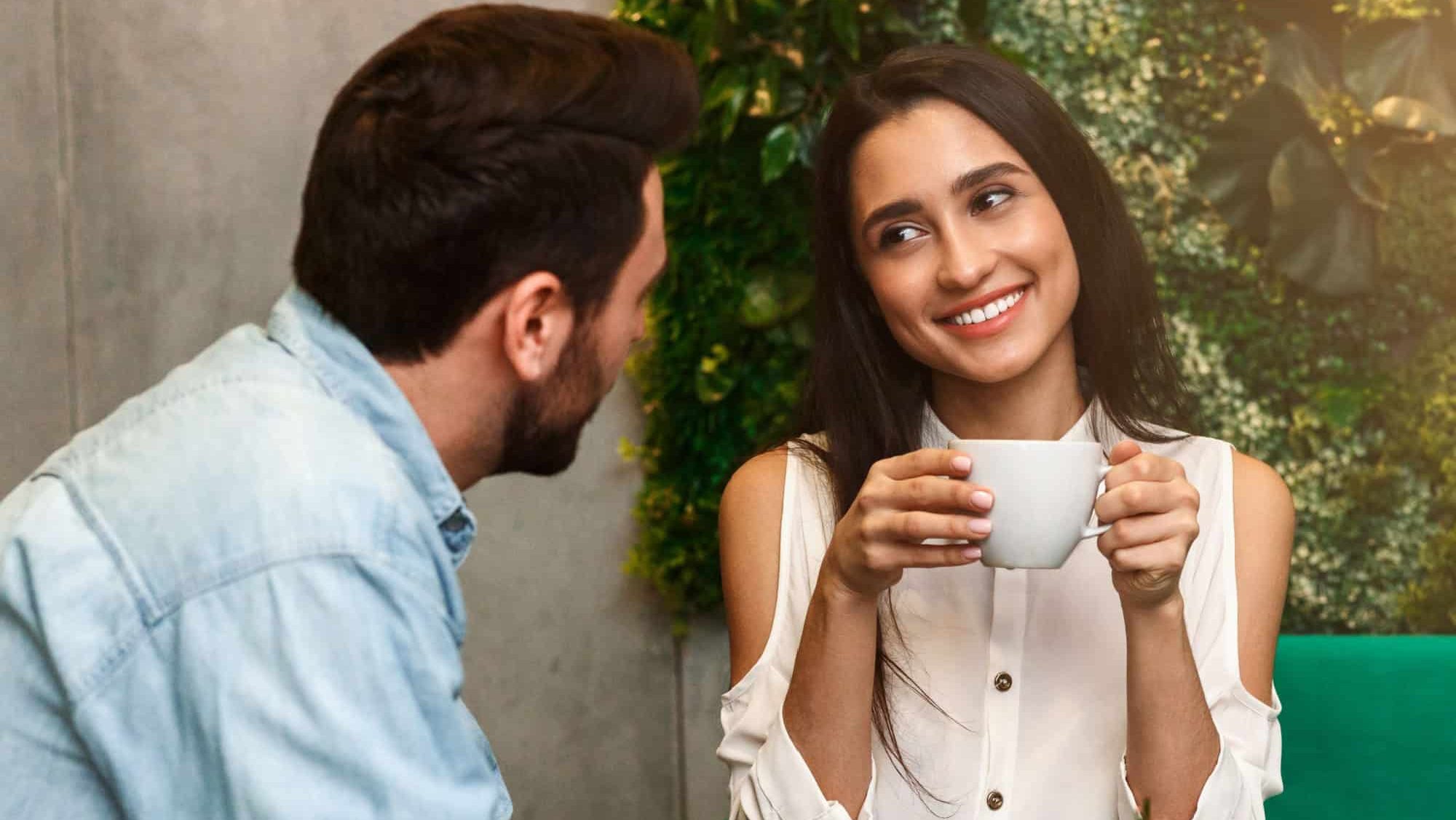 Happy Woman Talking Flirting With Boyfriend On Romantic Morning Date Sitting In Coffee Shop