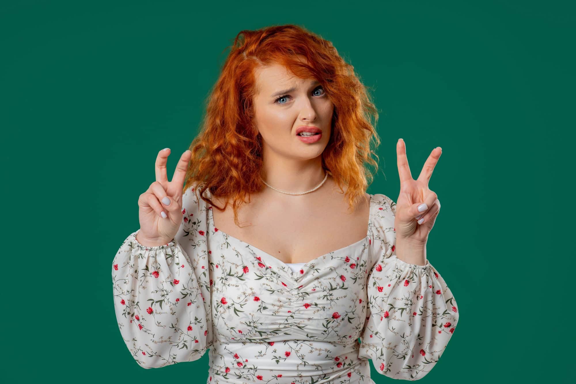 Attractive woman with hands two fingers air quotes gesture on green, sarcasm. High quality