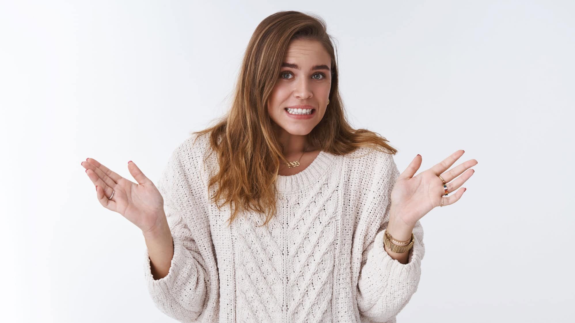 Oops sorry my fault. Portrait awkward guilty cute silly woman making mistake apologizing stooping clenching teeth uncomfortable feeling raising palms surrender, standing white background worried
