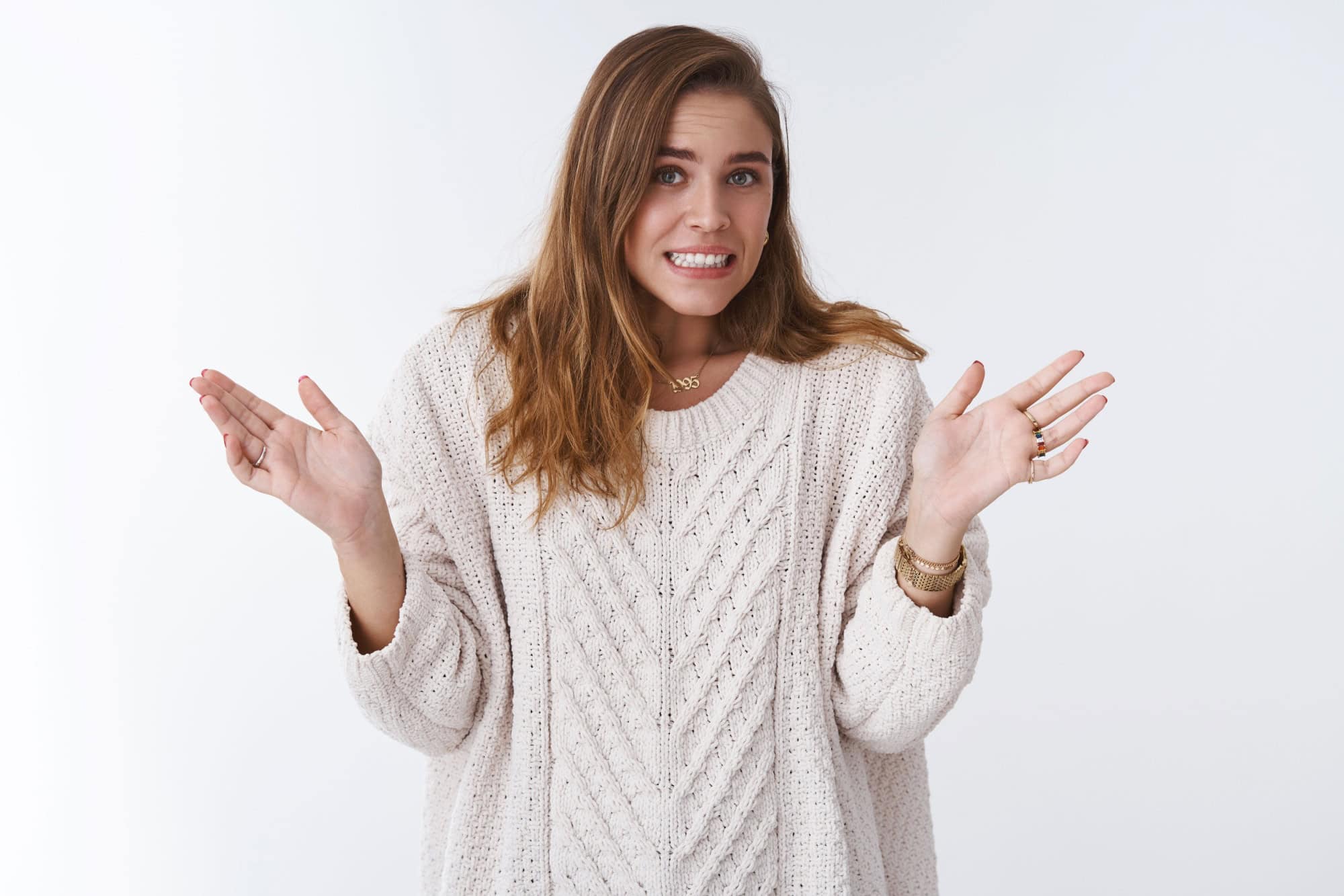 Oops sorry my fault. Portrait awkward guilty cute silly woman making mistake apologizing stooping clenching teeth uncomfortable feeling raising palms surrender, standing white background worried