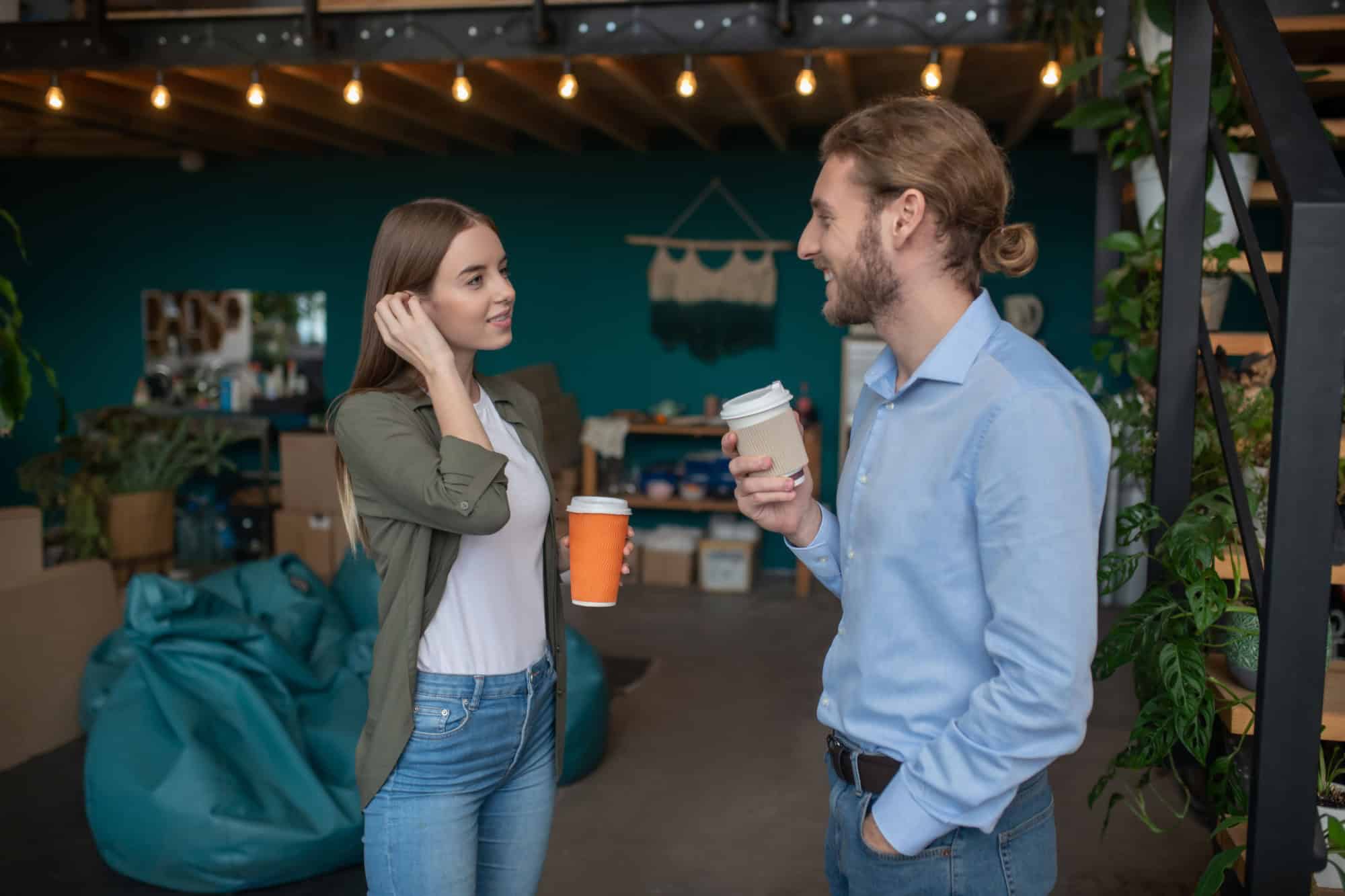 Small talk. A man and a woman chatting and drinking coffee