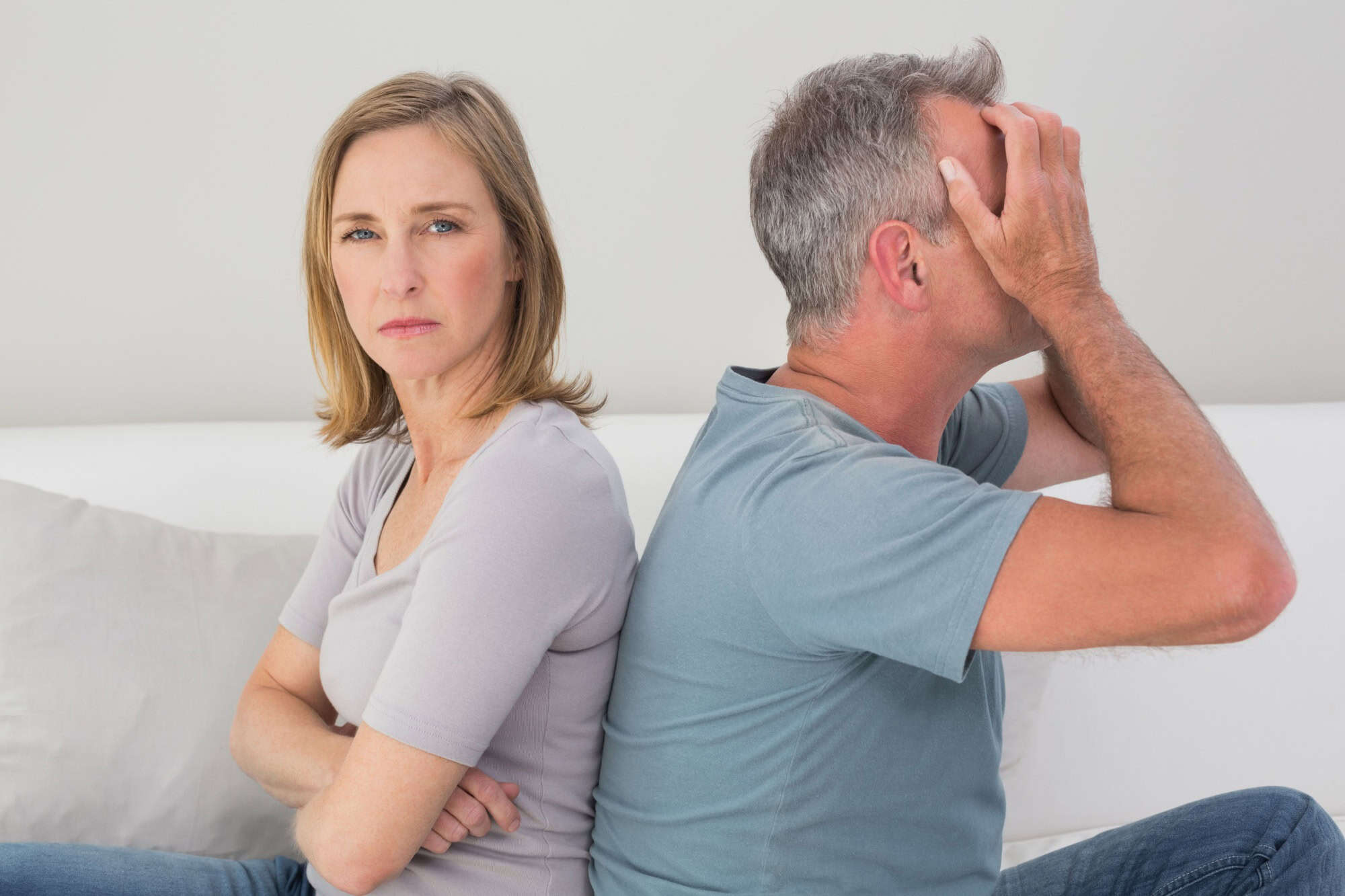 Unhappy couple not talking after an argument in the living room at home