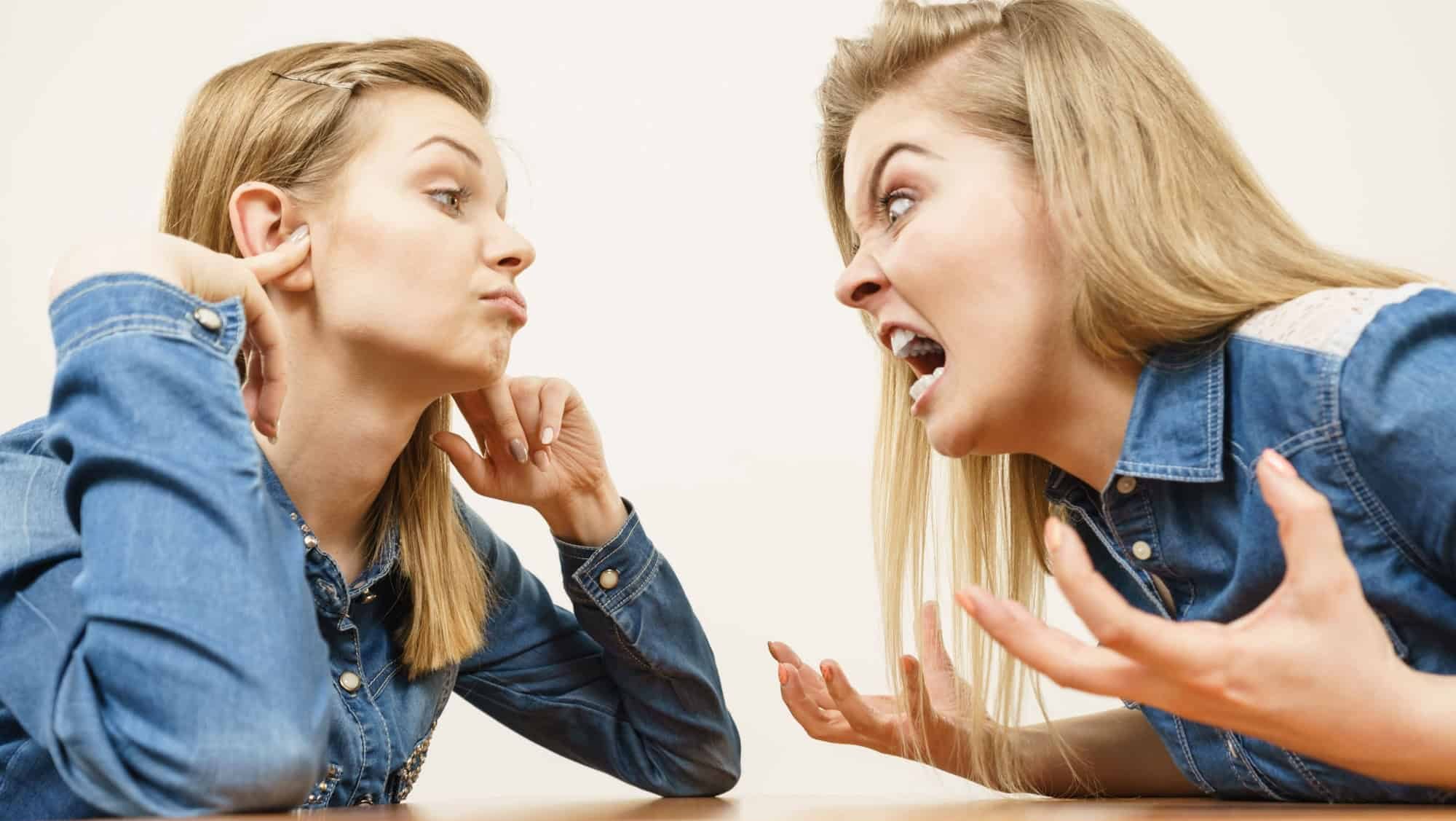 Two women having argue mocking up being mad at each other. Female telling off, ignorance concept.