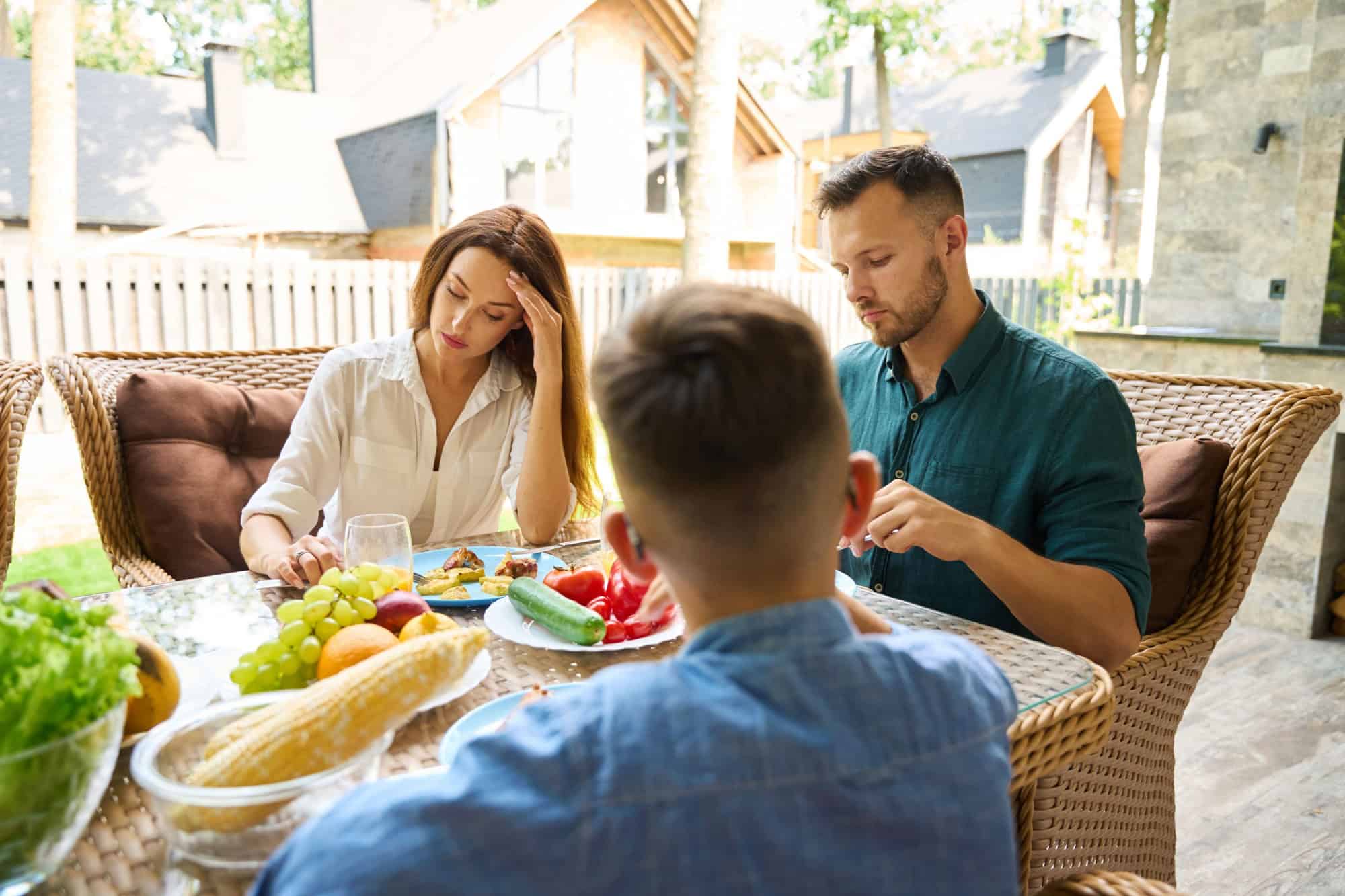 Man and woman are sitting upset at lunch on terrace