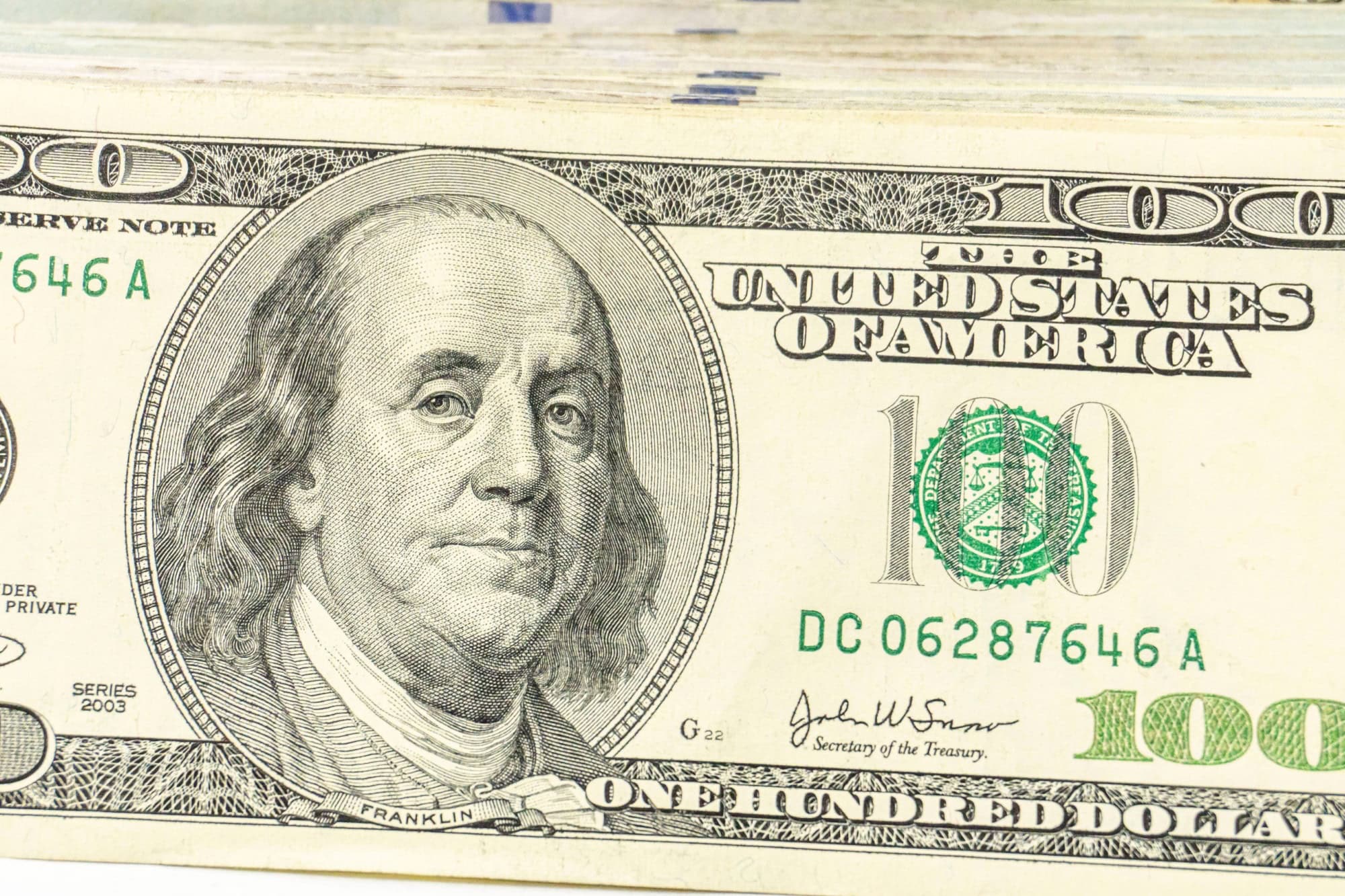 Close up view of cash money, 100 one hundred US dollar bills, 50 US dollar bills, 20 US dollar bills, lots of cash.