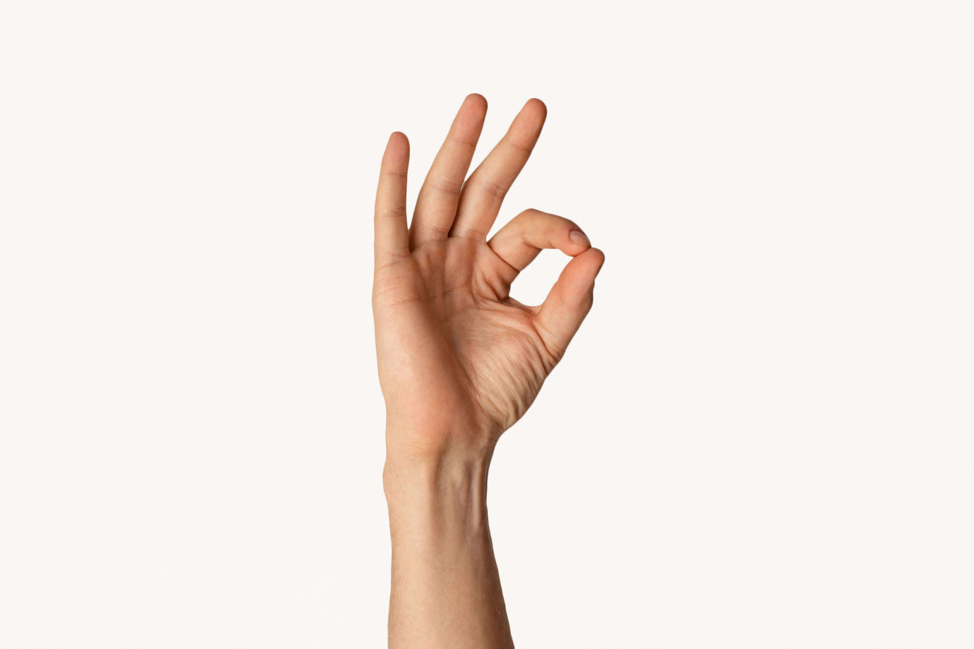 Close up of millenial guy showing OK gesture, expressing positivity on white background. Panorama