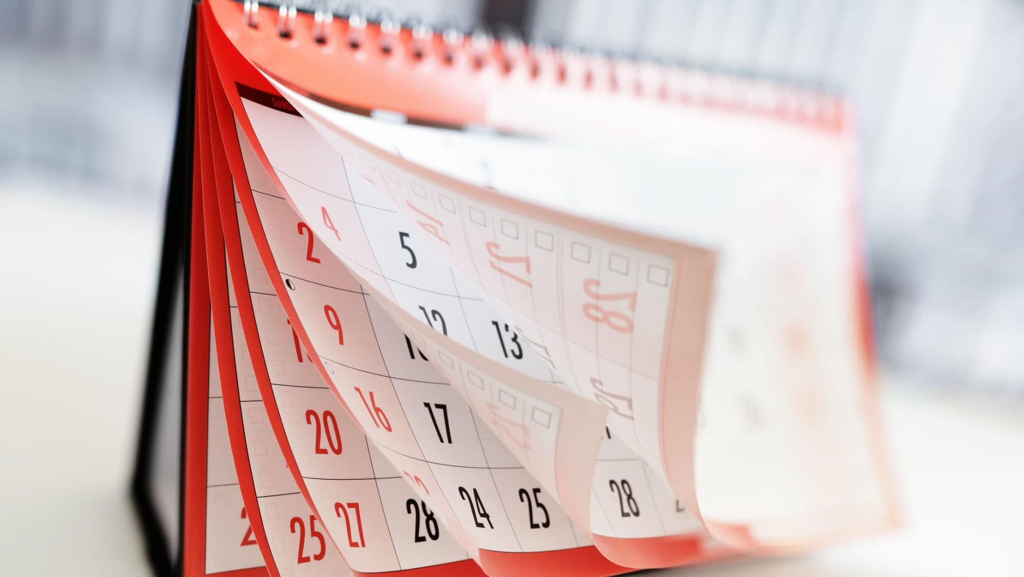 Months and dates shown on a calendar whilst turning the pages