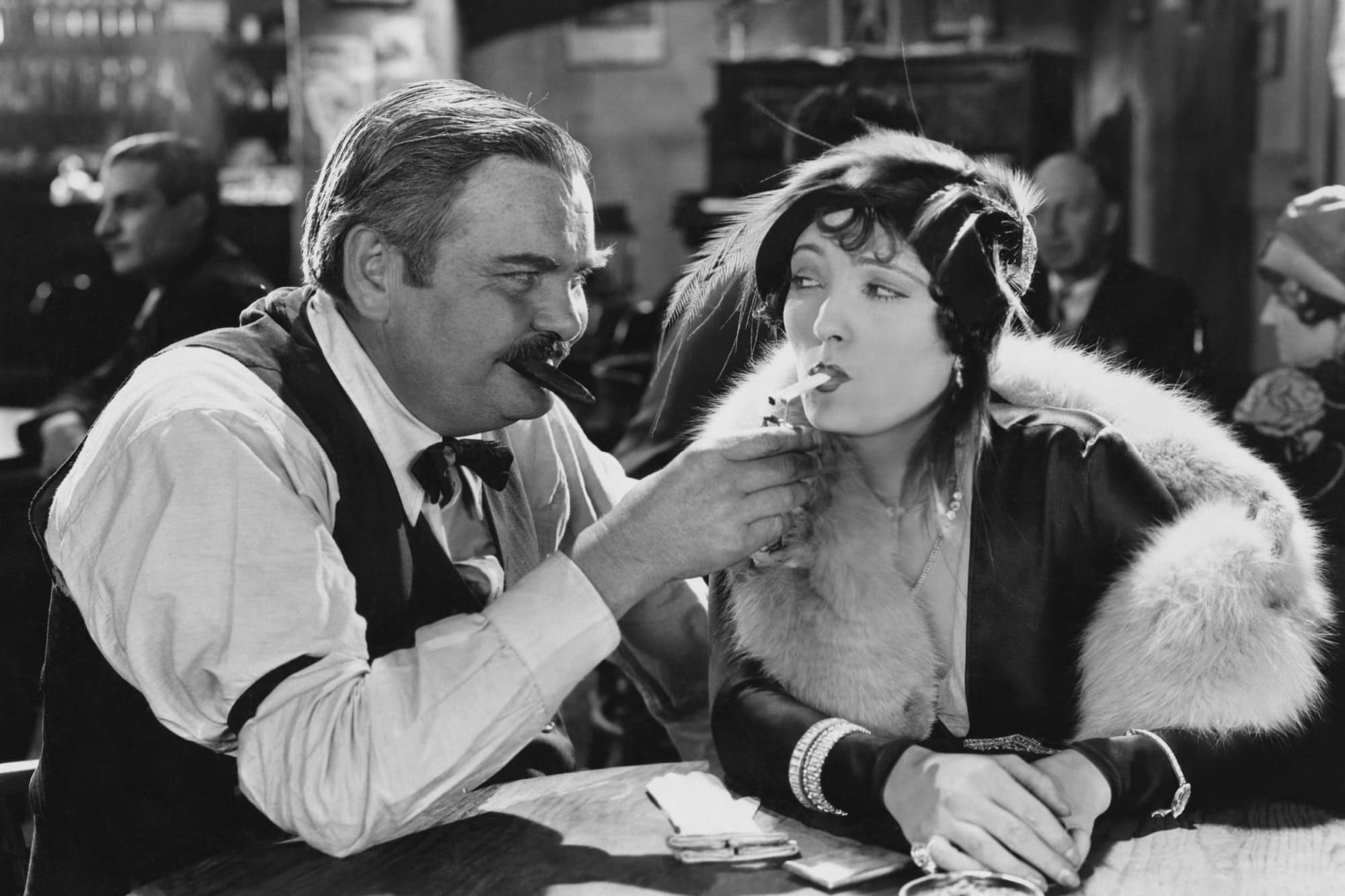 Man lighting woman's cigarette