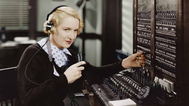Woman operating switchboard, vintage phone, retro
