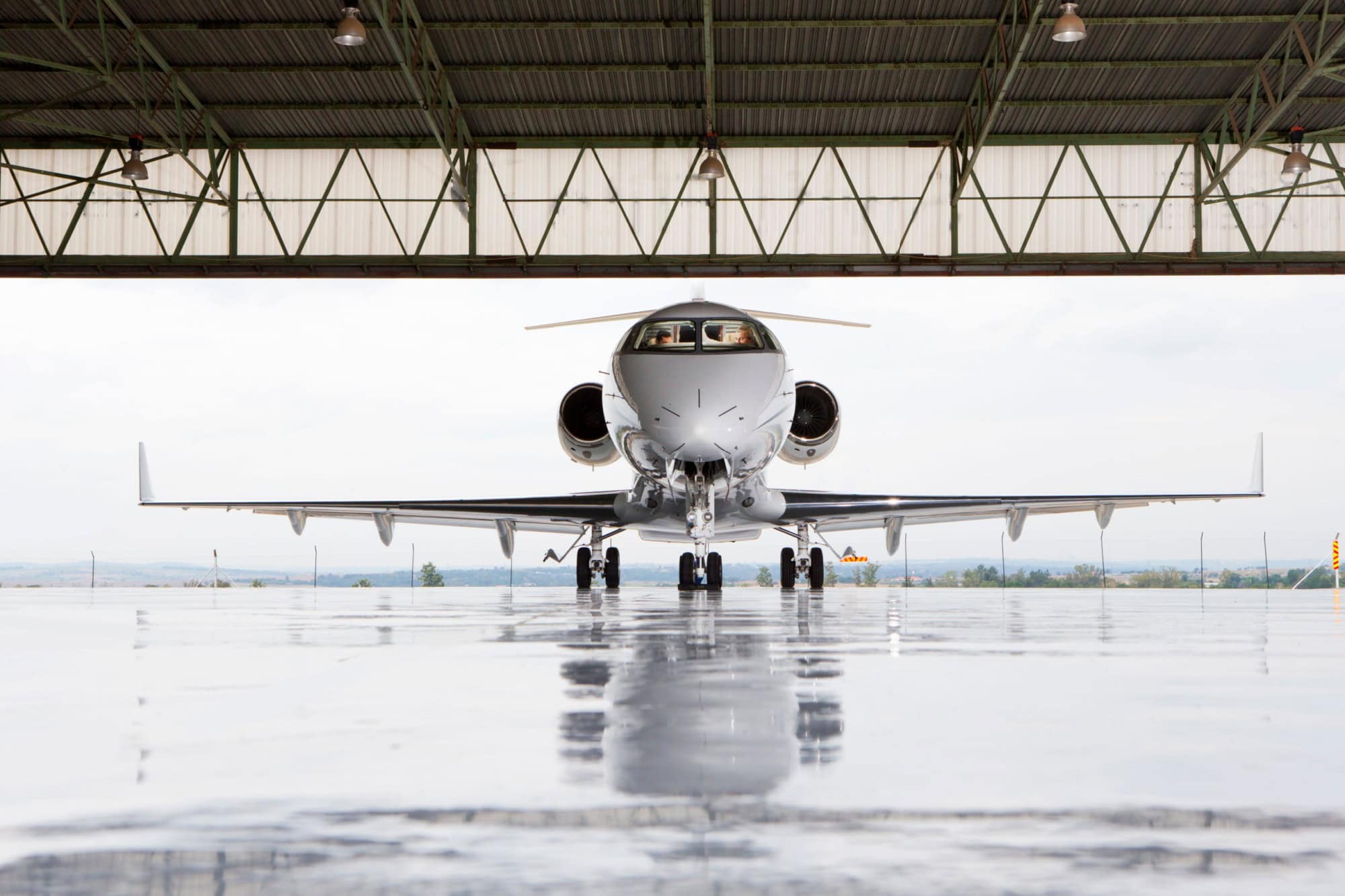 Pilots in private jet in hangar