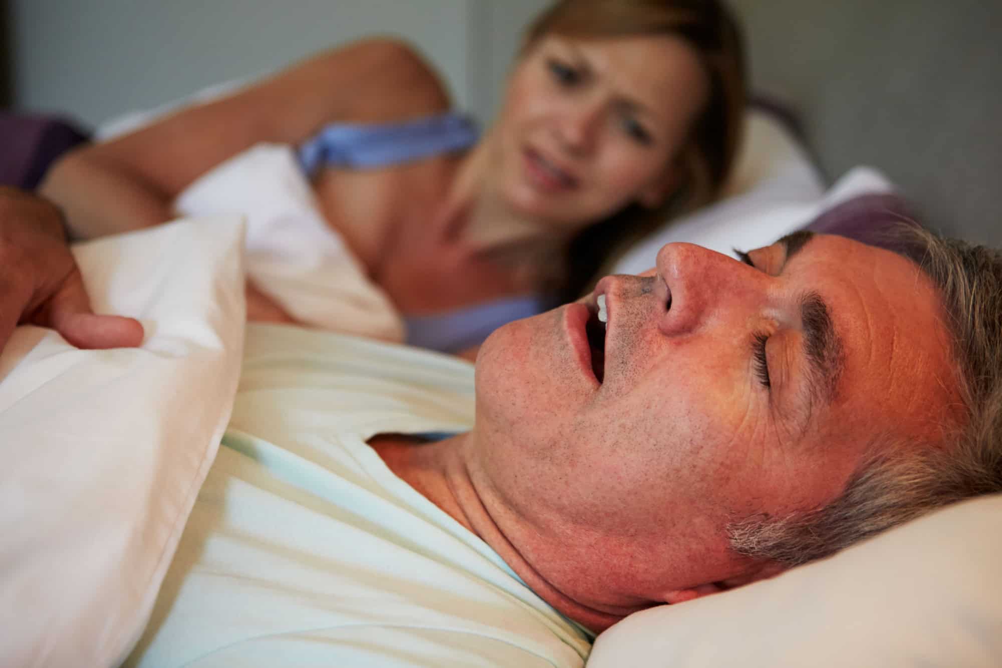 Man Keeping Woman Awake In Bed With Snoring