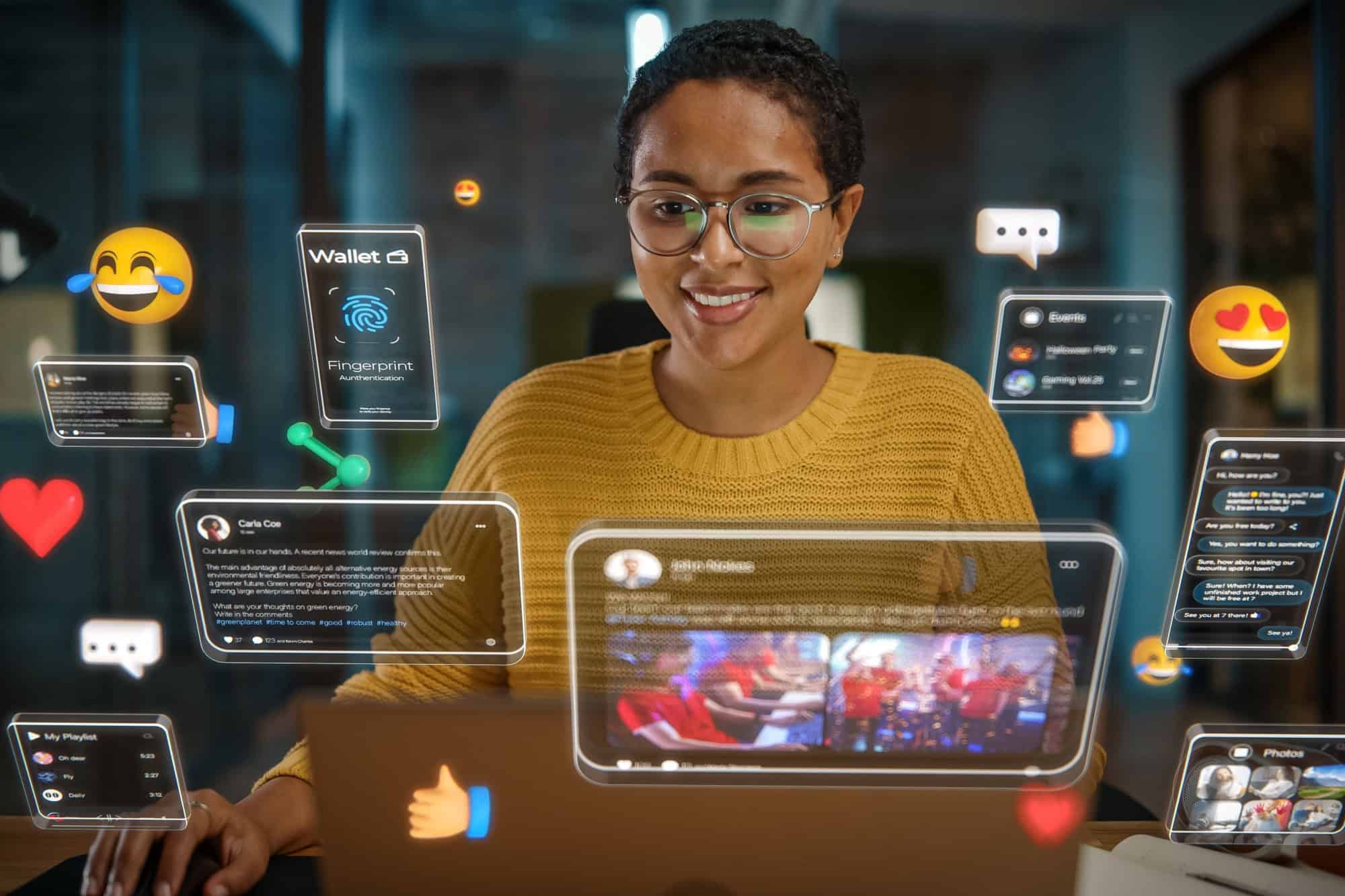 Beautiful Short Haired Project Manager Working on Computer in Office. Augmented Reality Social Media Icons Appear From Worker's Laptop. Internet of Things, Connectivity and Online Concept.