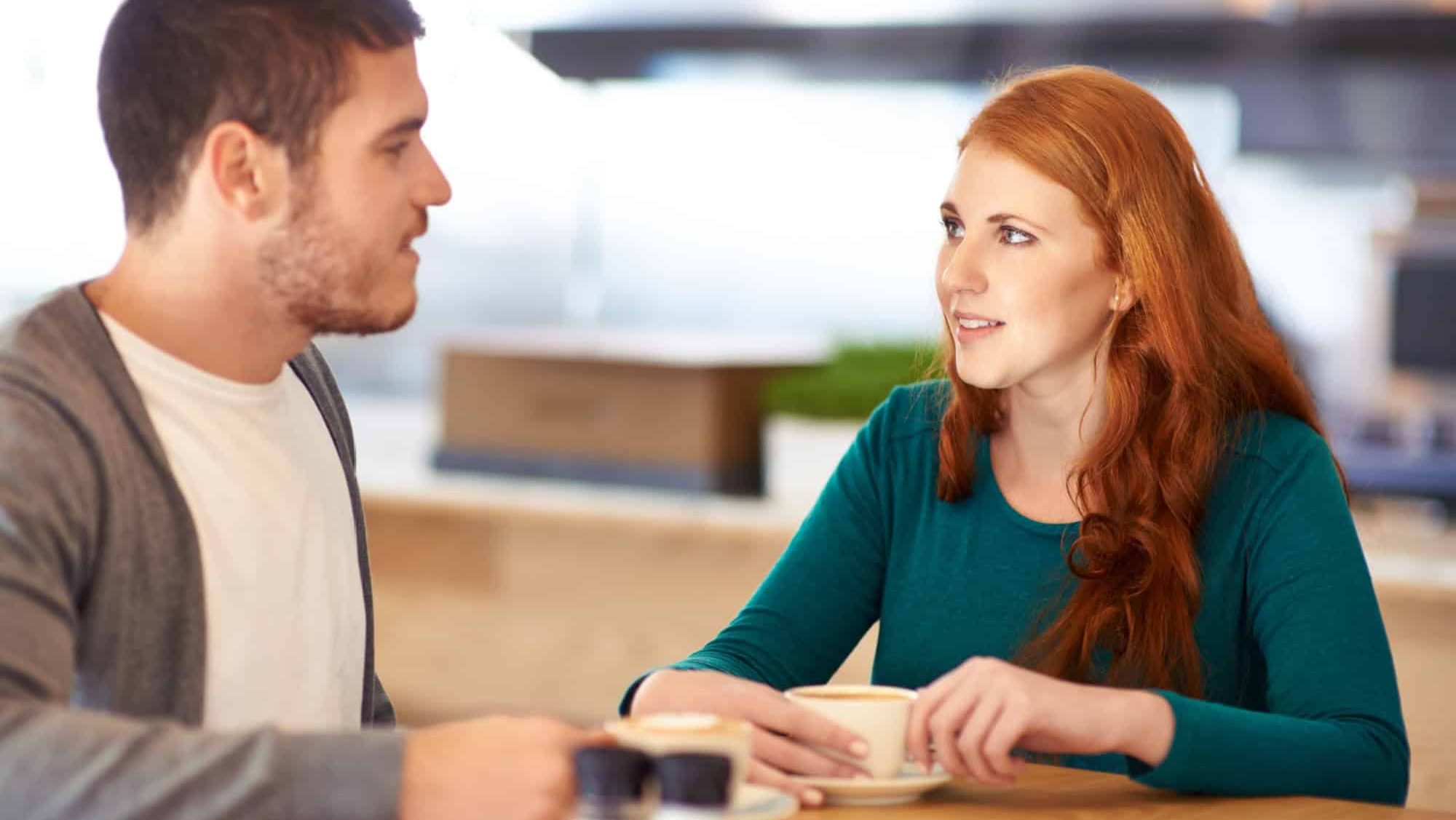 Restaurant, date and couple with coffee, love and conversation with romance and flirt. Cafe, man and woman with morning tea and bonding together with care and relationship with marriage and trust