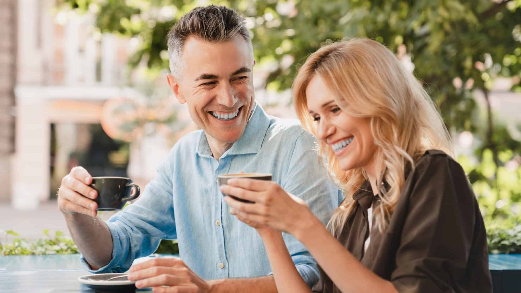 Bonding, love and relationship concept. Caucasian mature romantic couple spouses colleagues drinking enjoying coffee on a date together in cafe restaurant