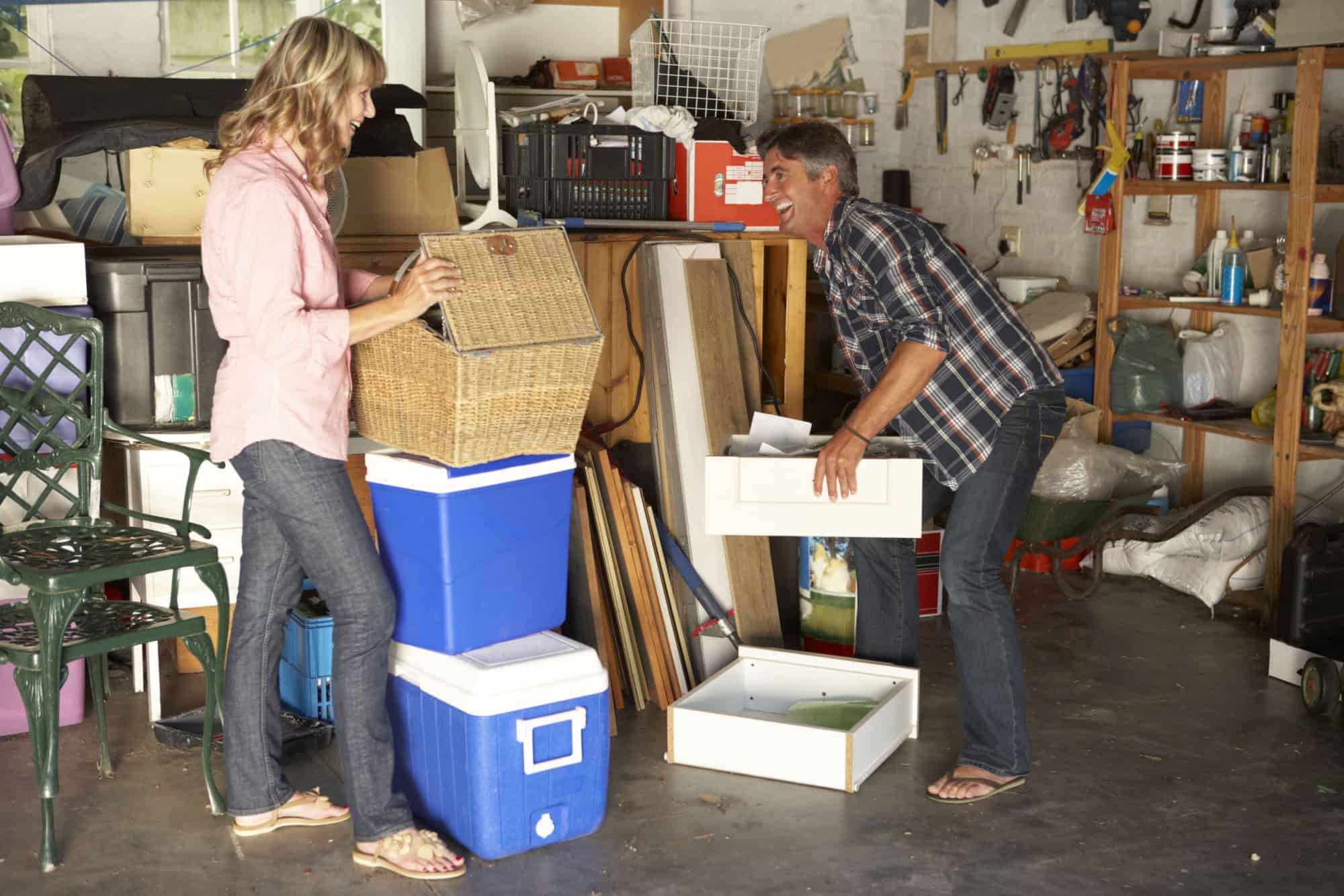Couple Clearing Messy Garage For Yard Sale