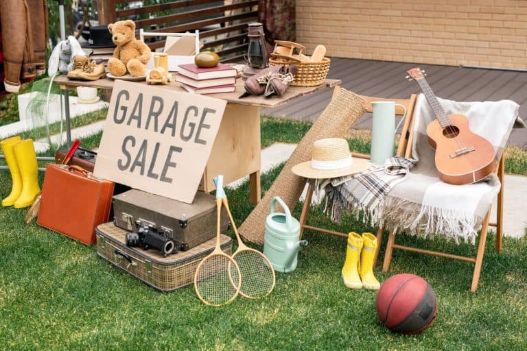 Various things placed on table and chairs in backyard, garage sale concept, reselling concept