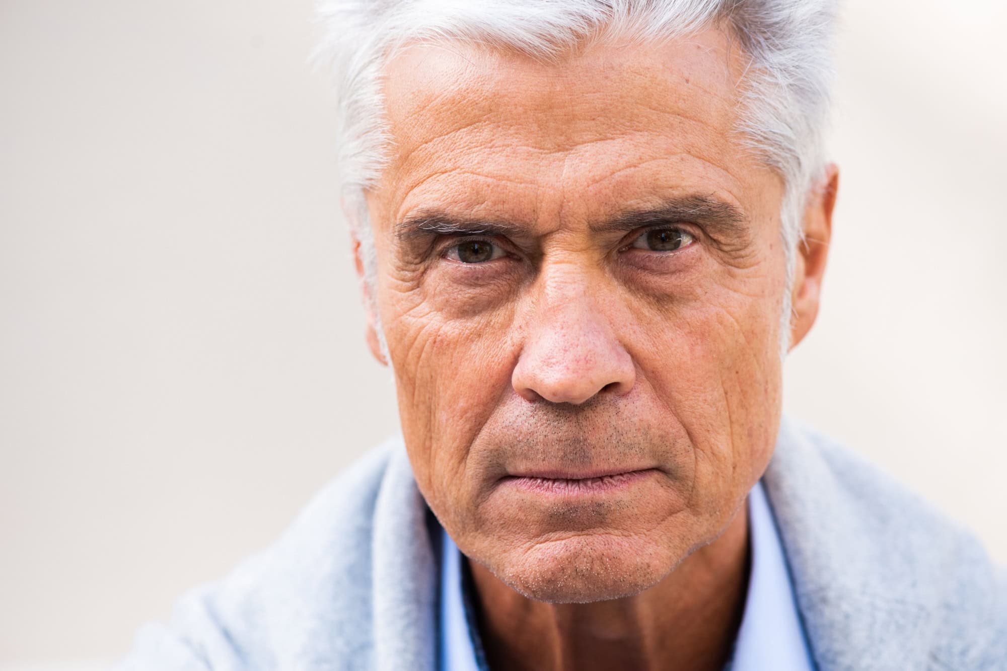 Close up face portrait serious older man eyes looking