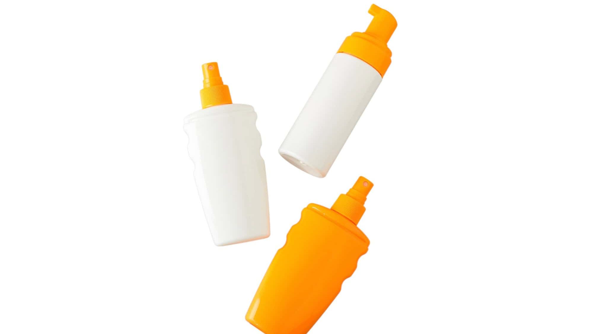 Three sunscreen bottles on a white background
