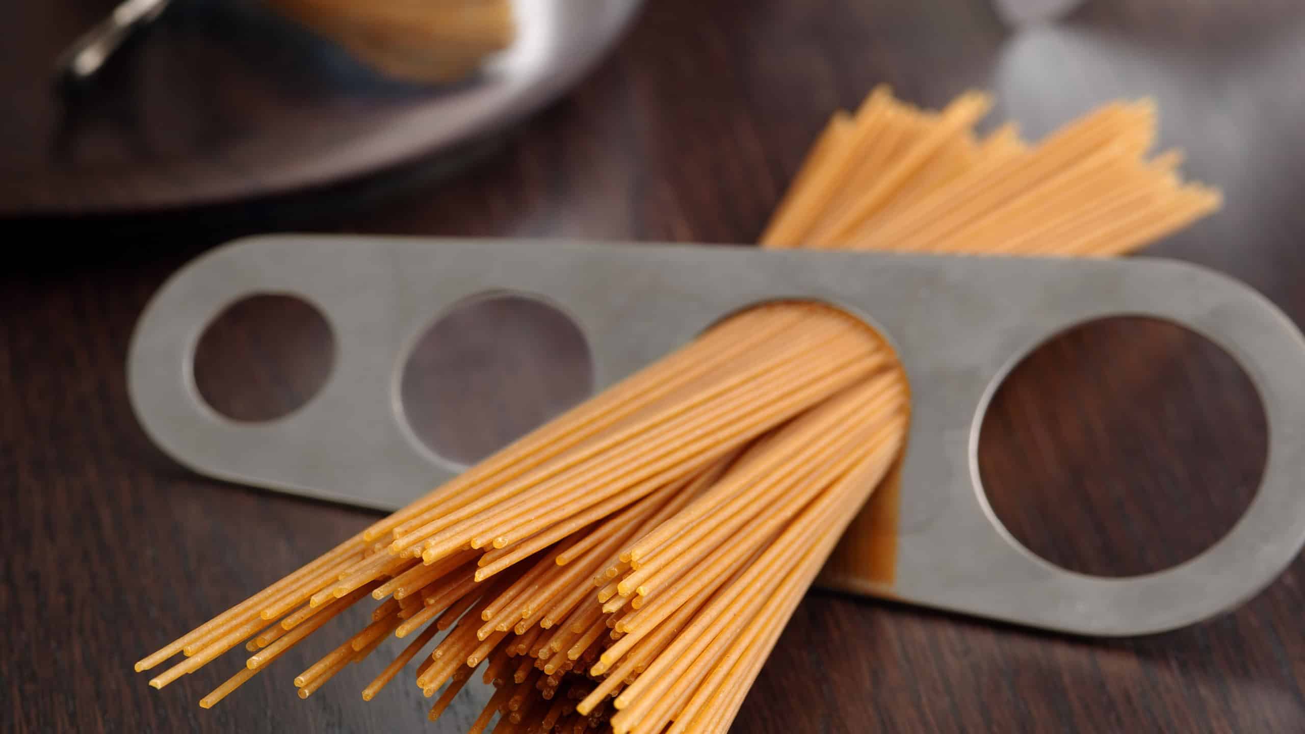 Photo of a portion of spaghetti measured and about to put into a pot for cooking.