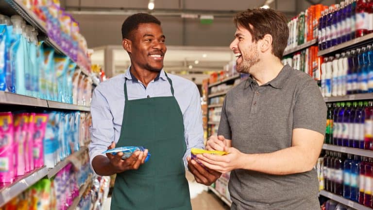 Friendly African seller in the supermarket at a customer consultation