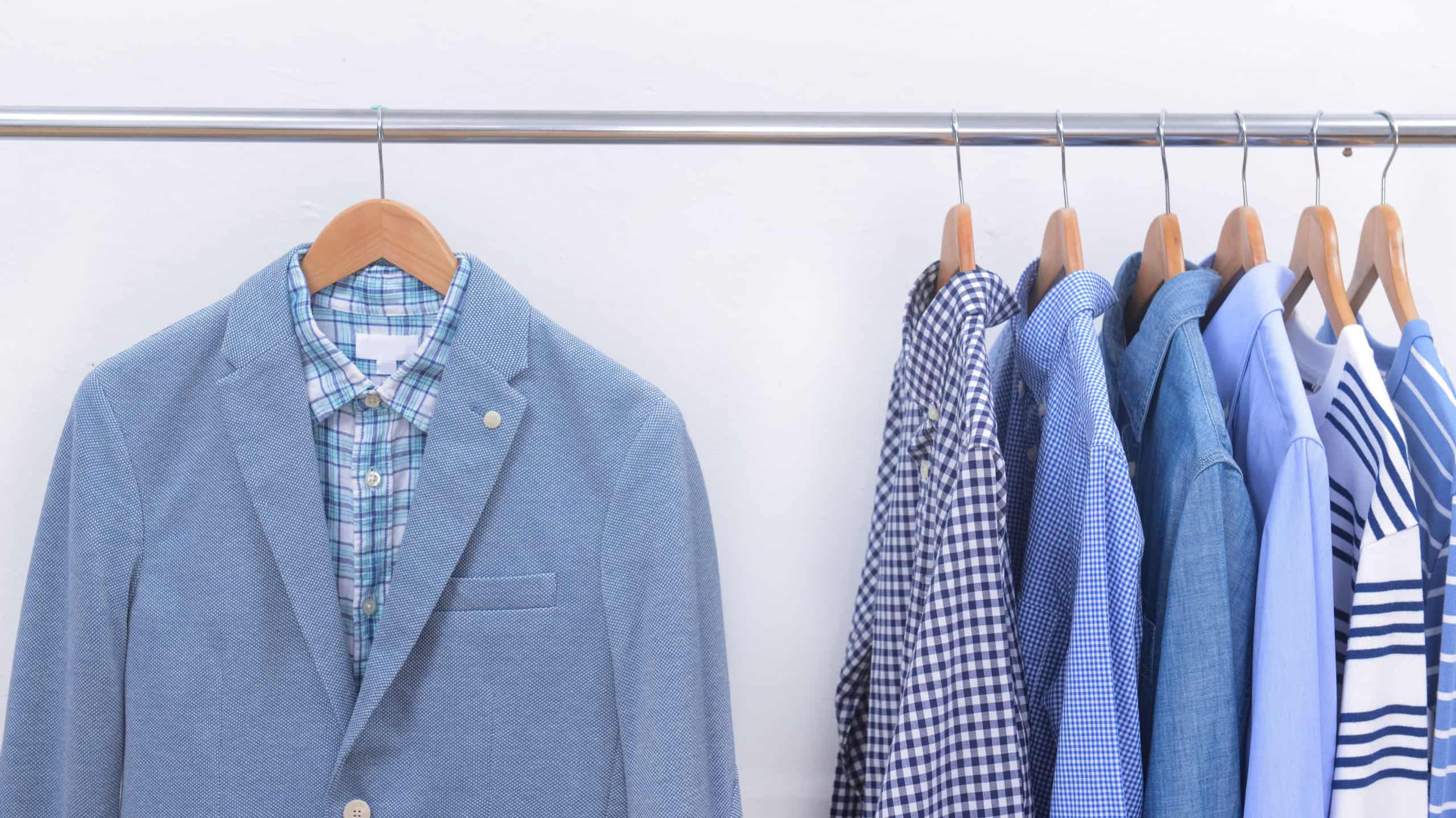 Men's plaid shirt close up of checkered with blue , white long sleeved white shirts on hanger